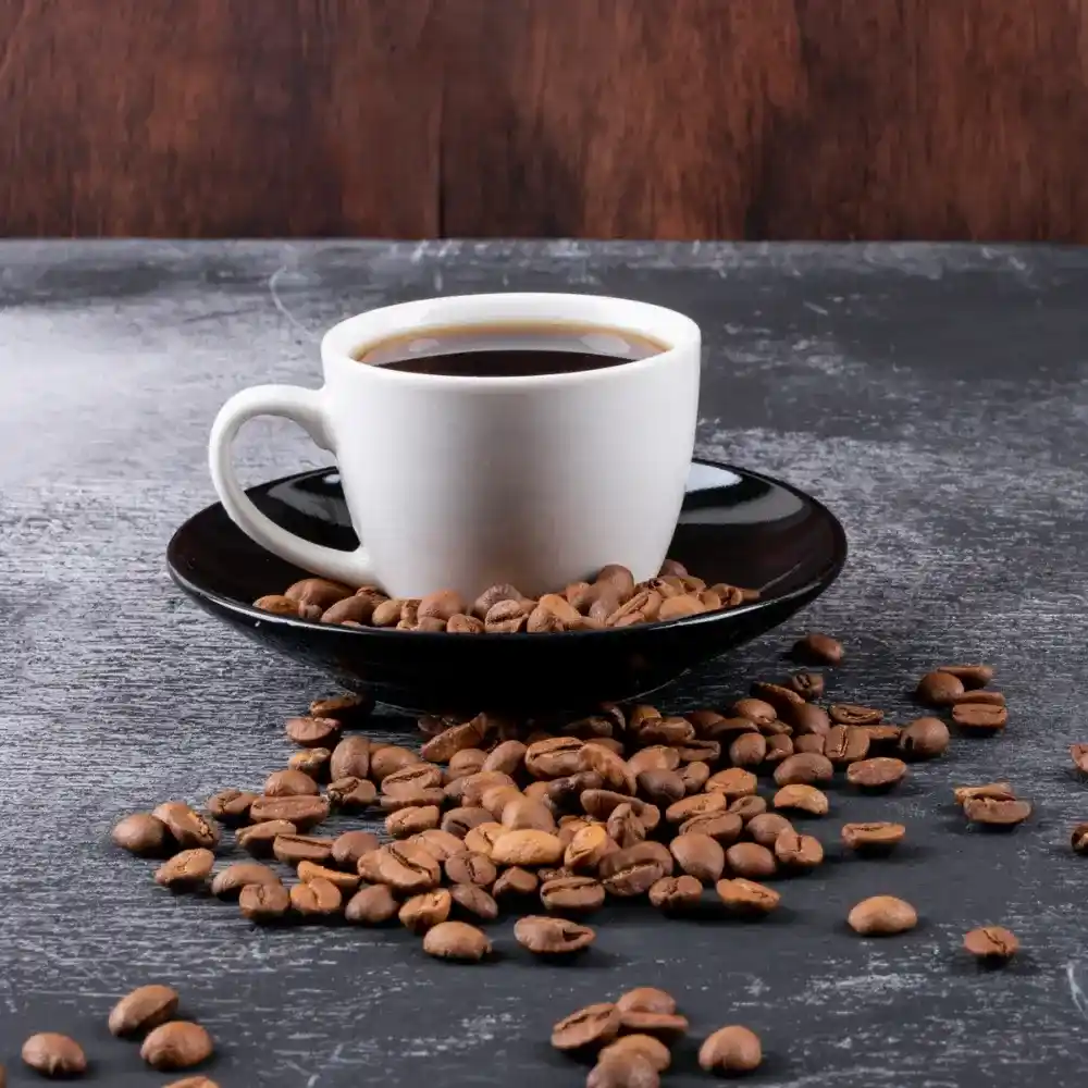 arabica coffee beans and a mug on a saucer