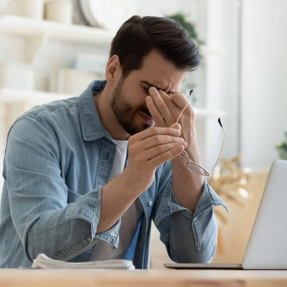 man holding his head in pain