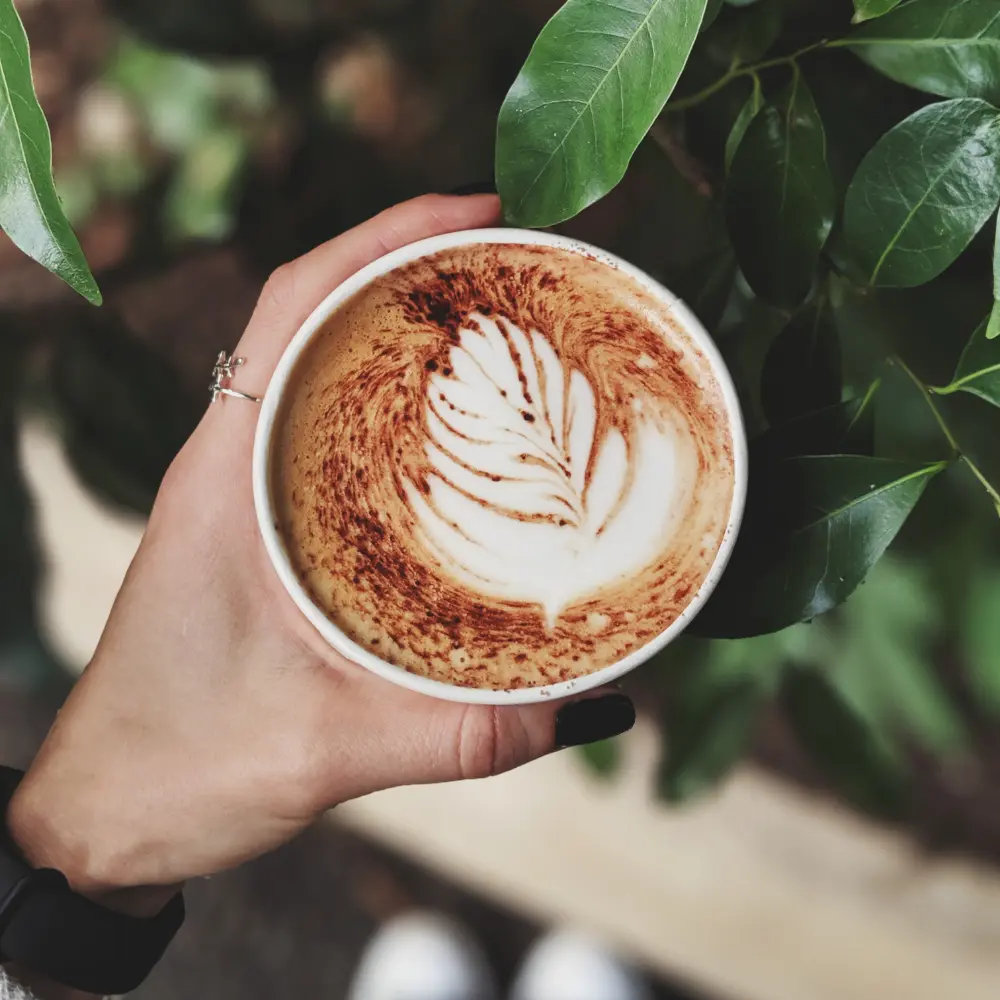 hand holding a lattee