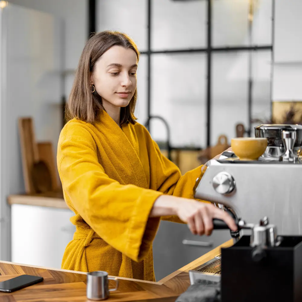 woman operating an espresso machine