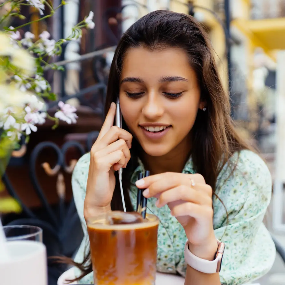 woman enjoying her dunkin sunrise batch iced coffee