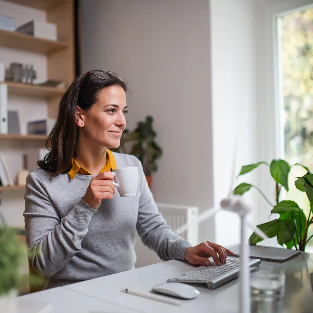 woman working and having a cup of coffee