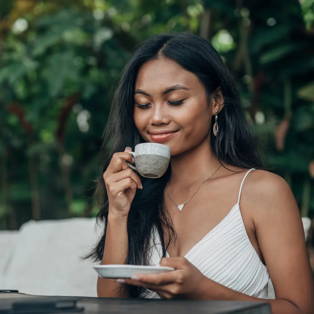 indonesian woman enjoying coffee