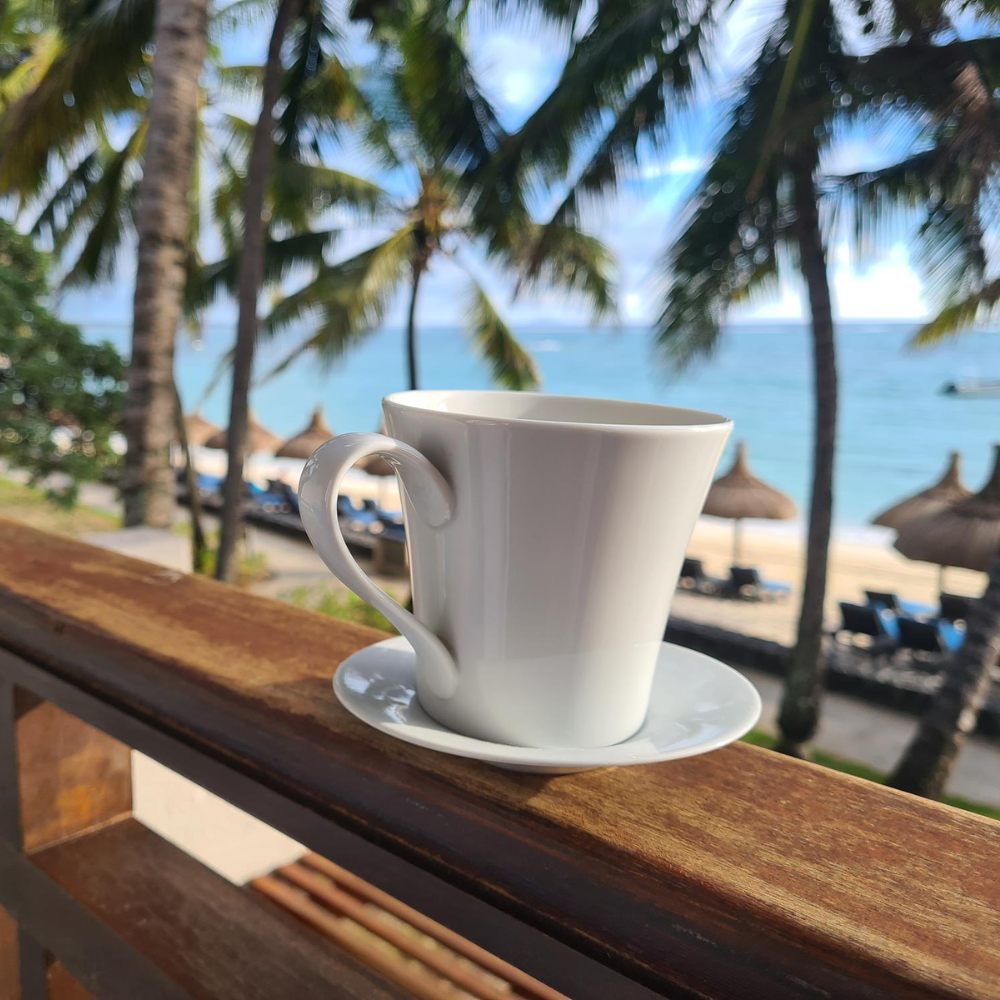 cup of coffee on a wooden beam in hawaii