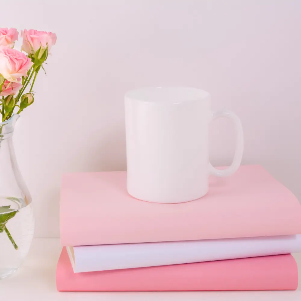 pink books and a coffee mug