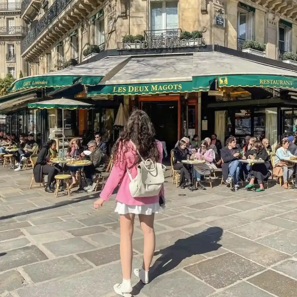 a young lady in front of les deux magots