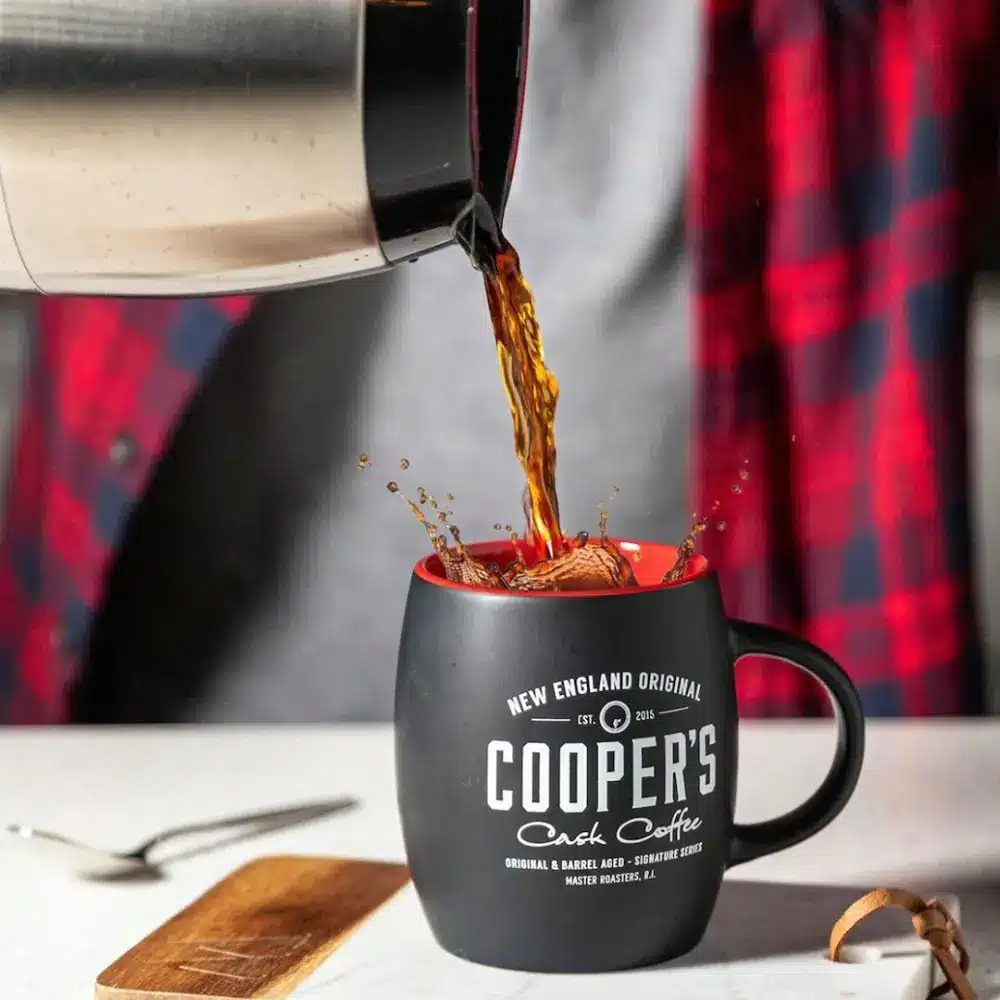 coffee pouring into a cooper's cask coffee mug