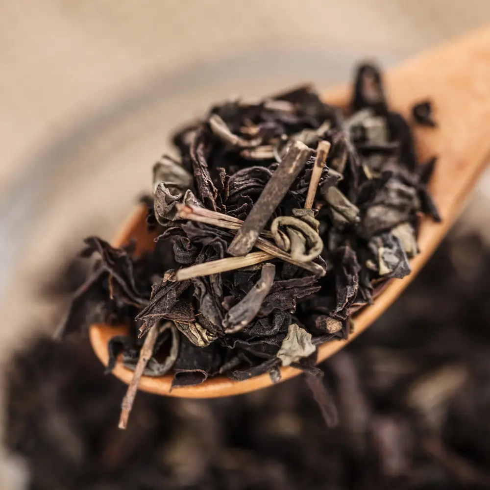 a wooden spoon of loose leaf tea