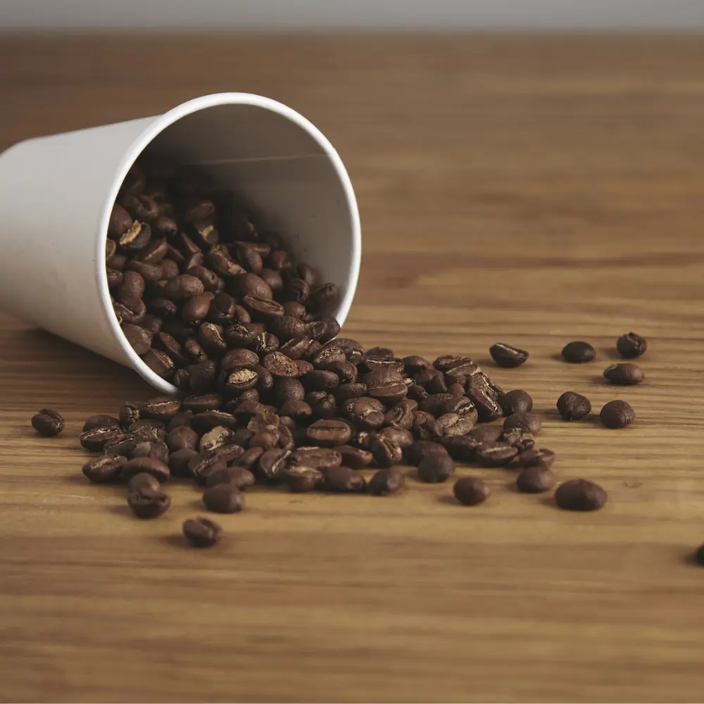 coffee beans spilling out of a cup