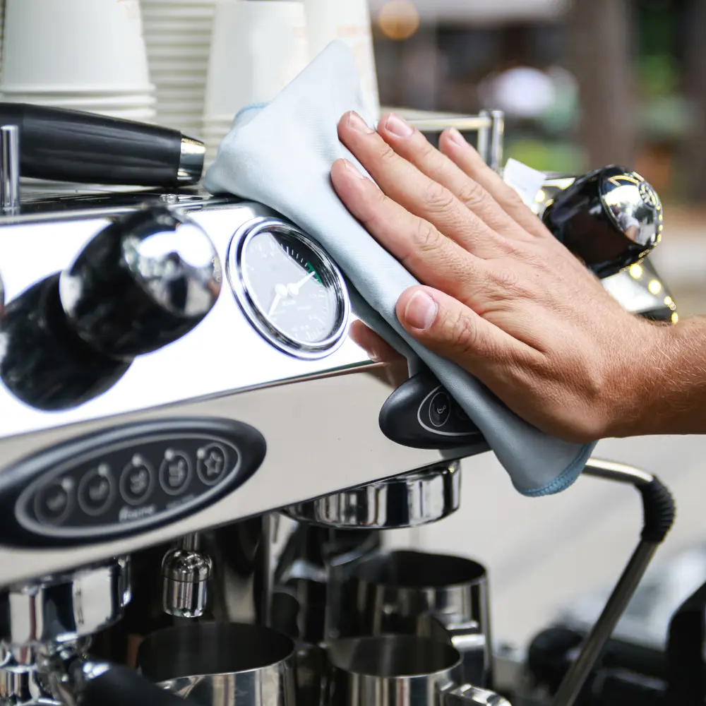 barista cleaning espresso machine