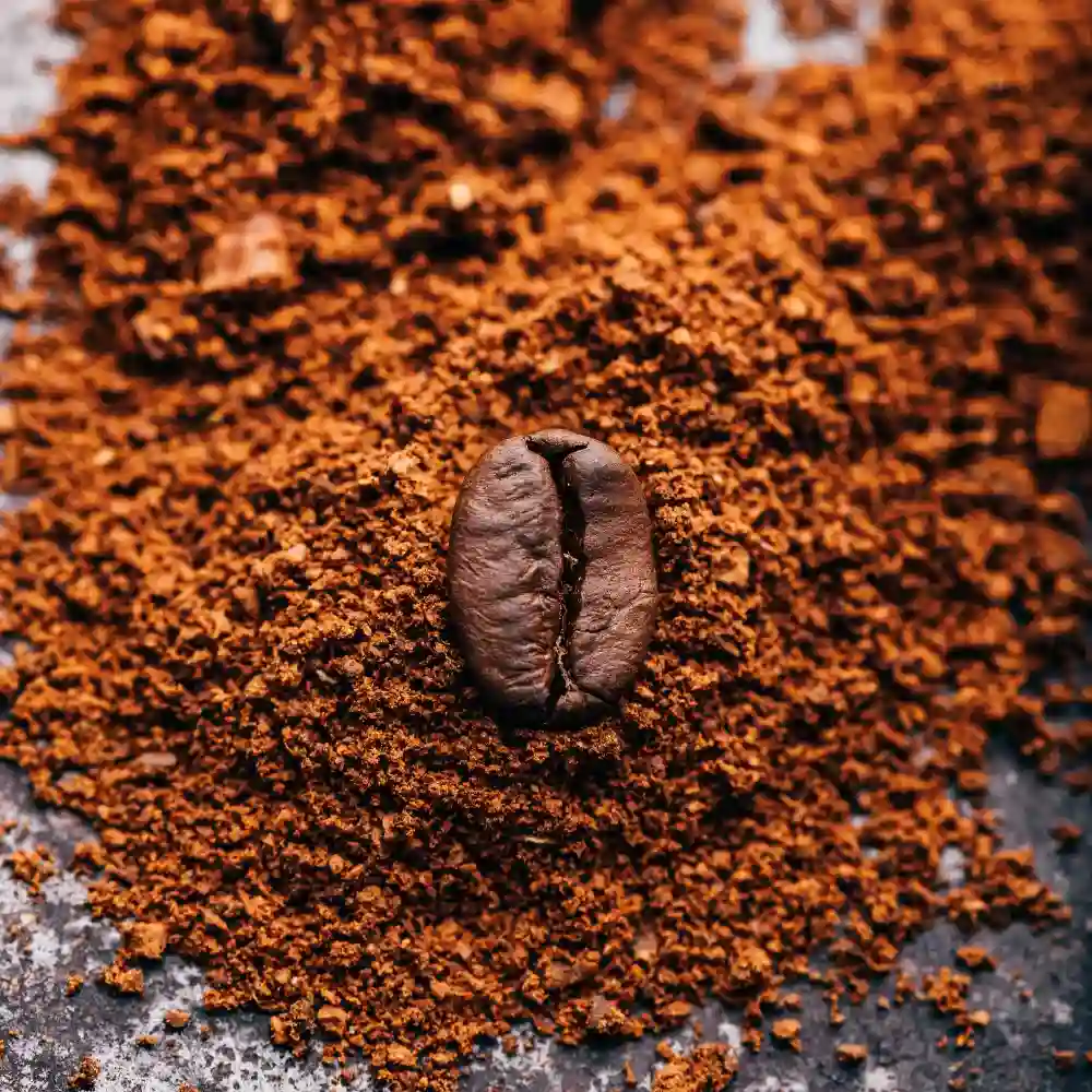 ground coffee and a bean