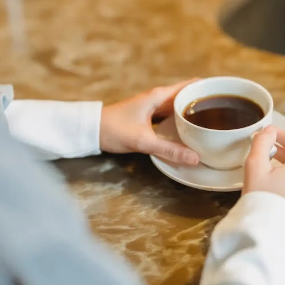woman holding a cup of americano
