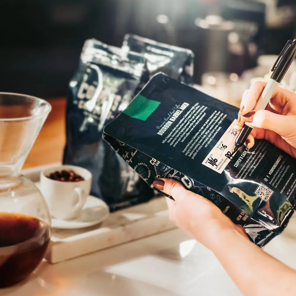 taking notes on a coopers cask coffee bag