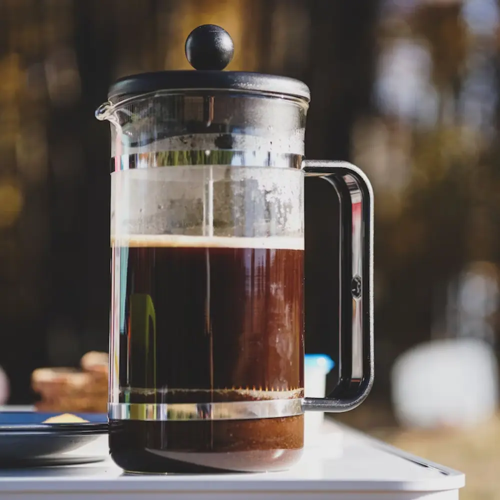 a french press coffee maker steeping coffee