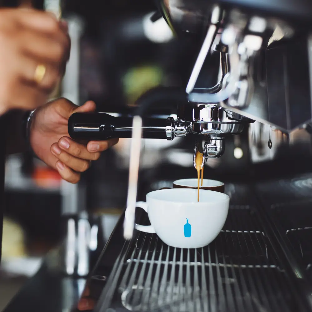 barista pressing a shot of espresso