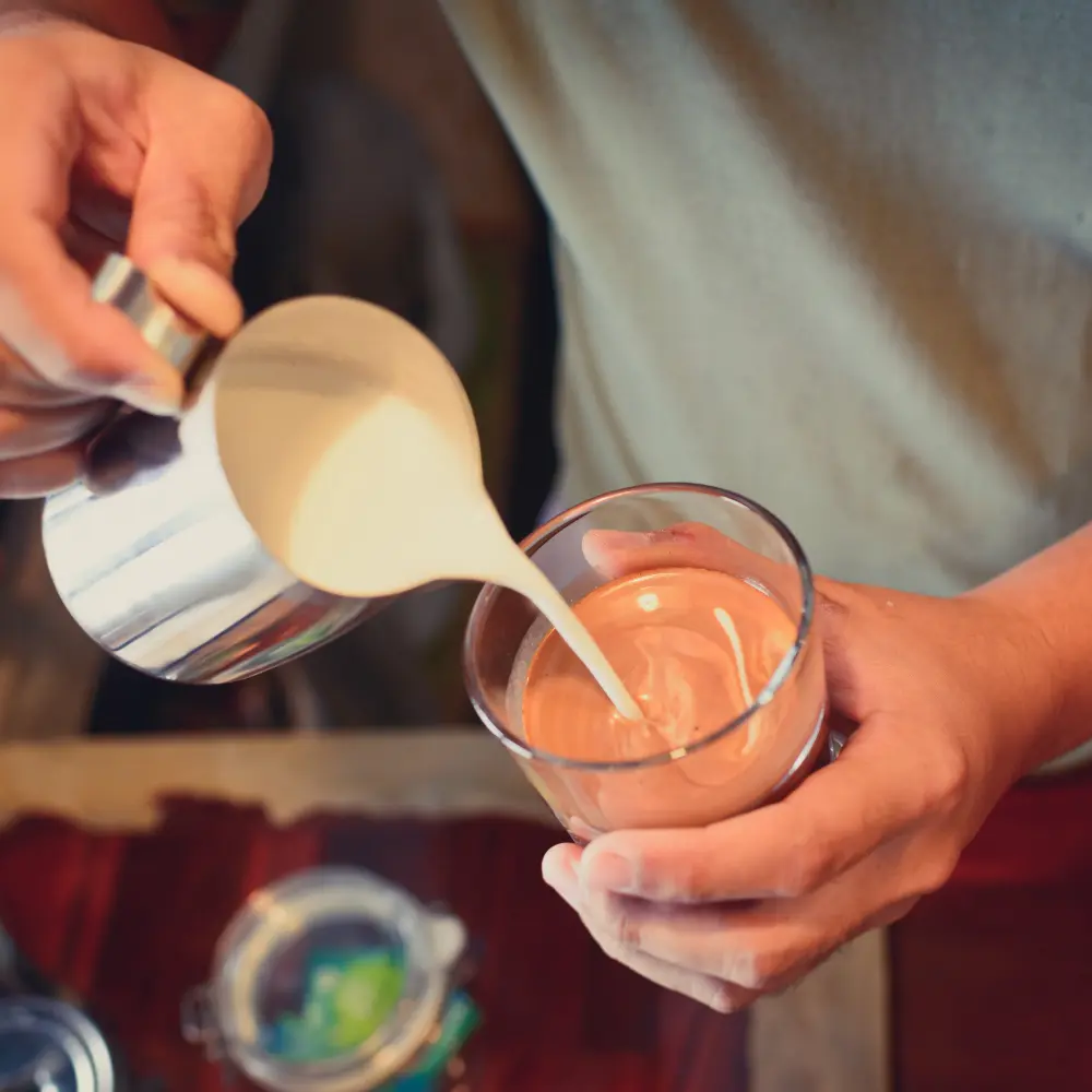 barista making a latte coffee drink