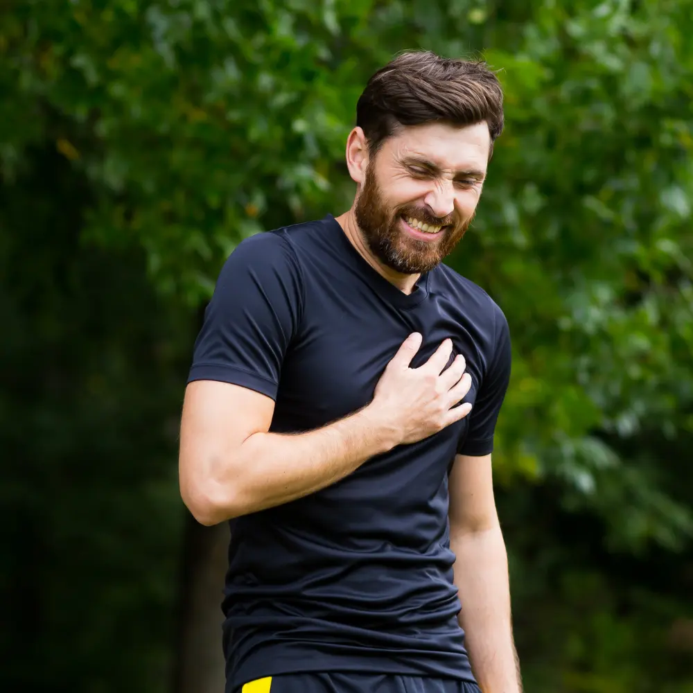 man holding his chest in pain