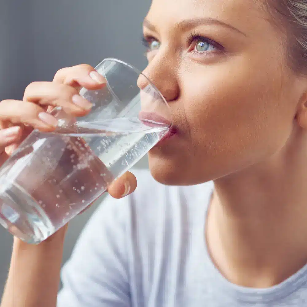 woman drinking a glass of water