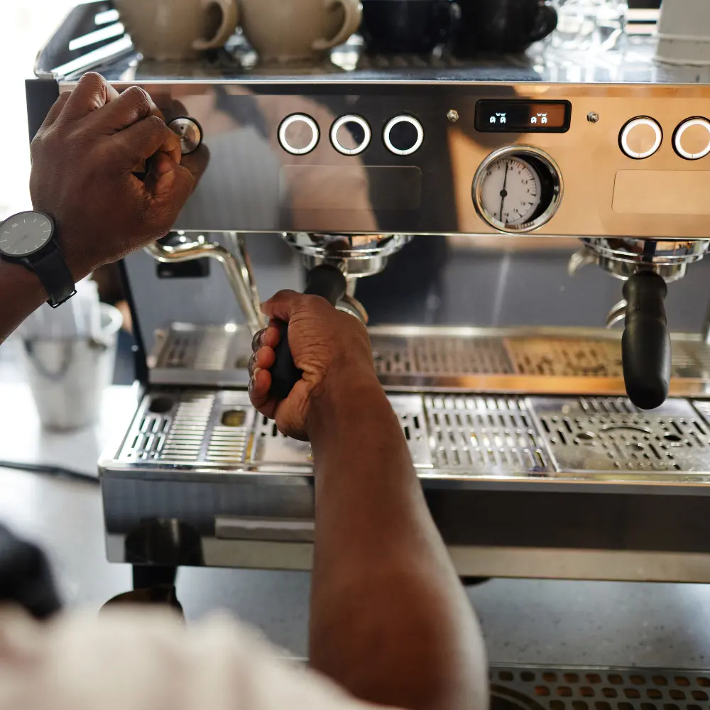 barista inserting a portafilter into an espresso machine