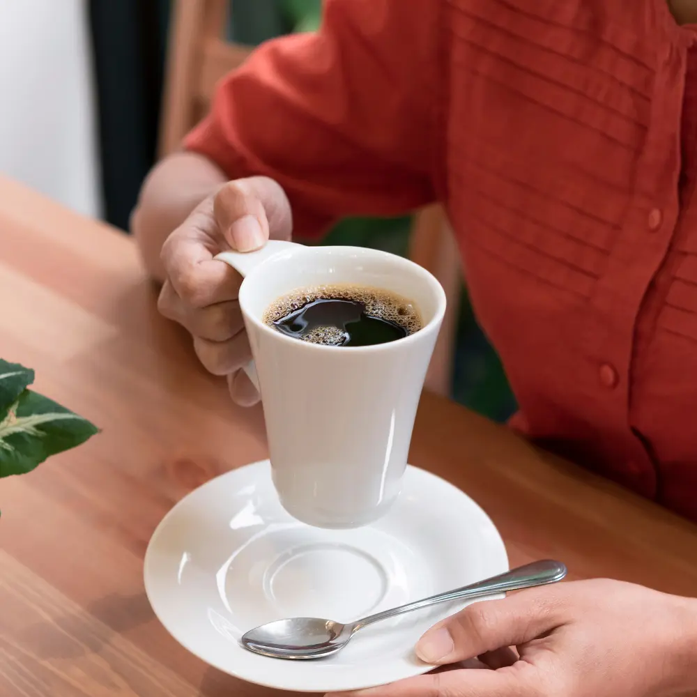 person enjoying an americano coffee