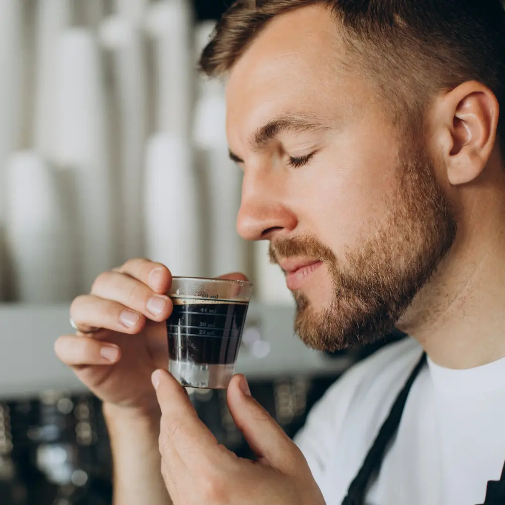 barista smelling an espresso