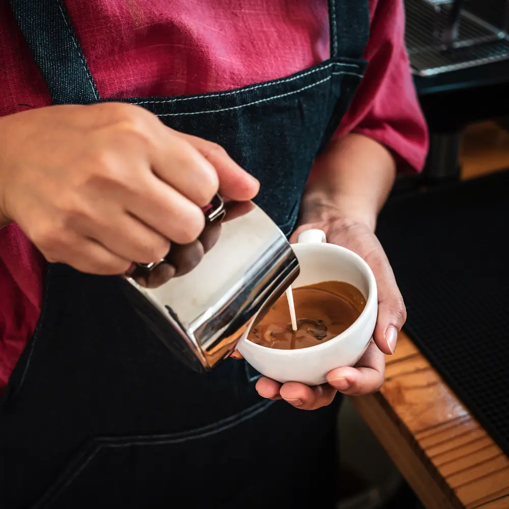 barista making a milk coffee