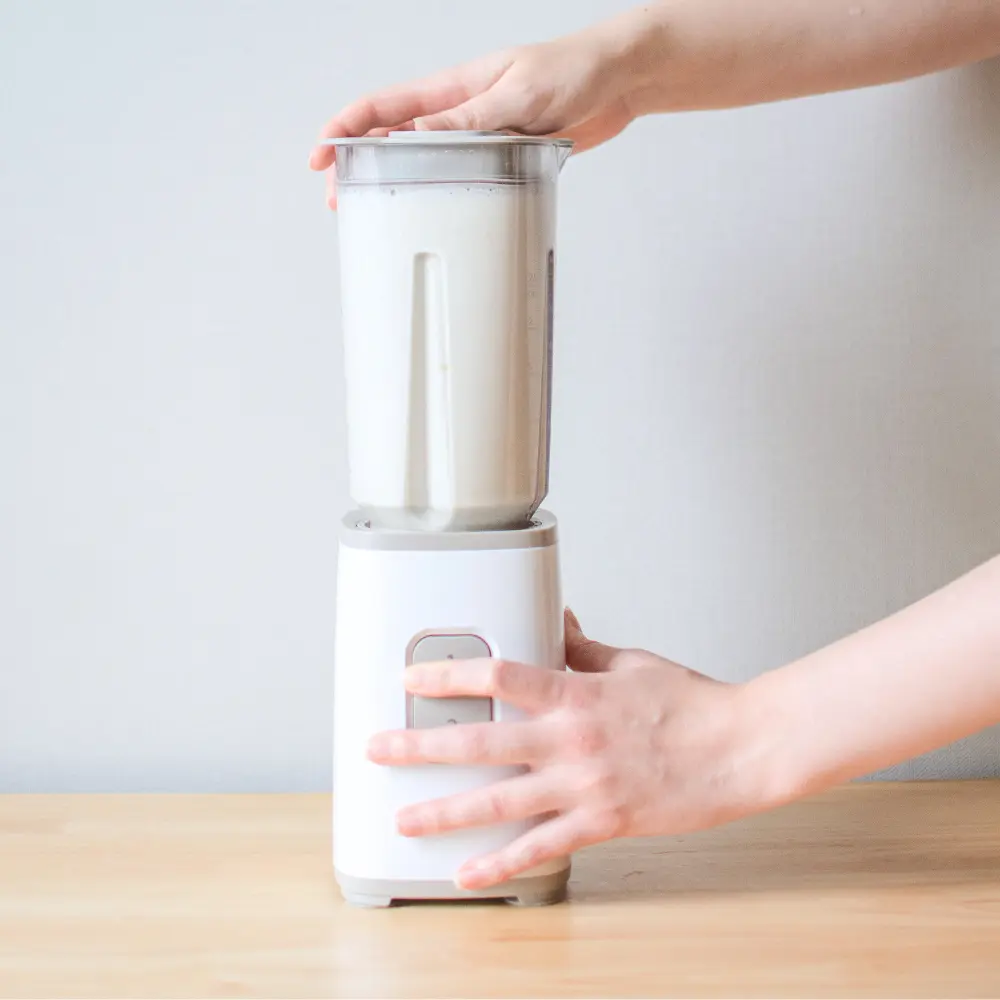 person using a blender