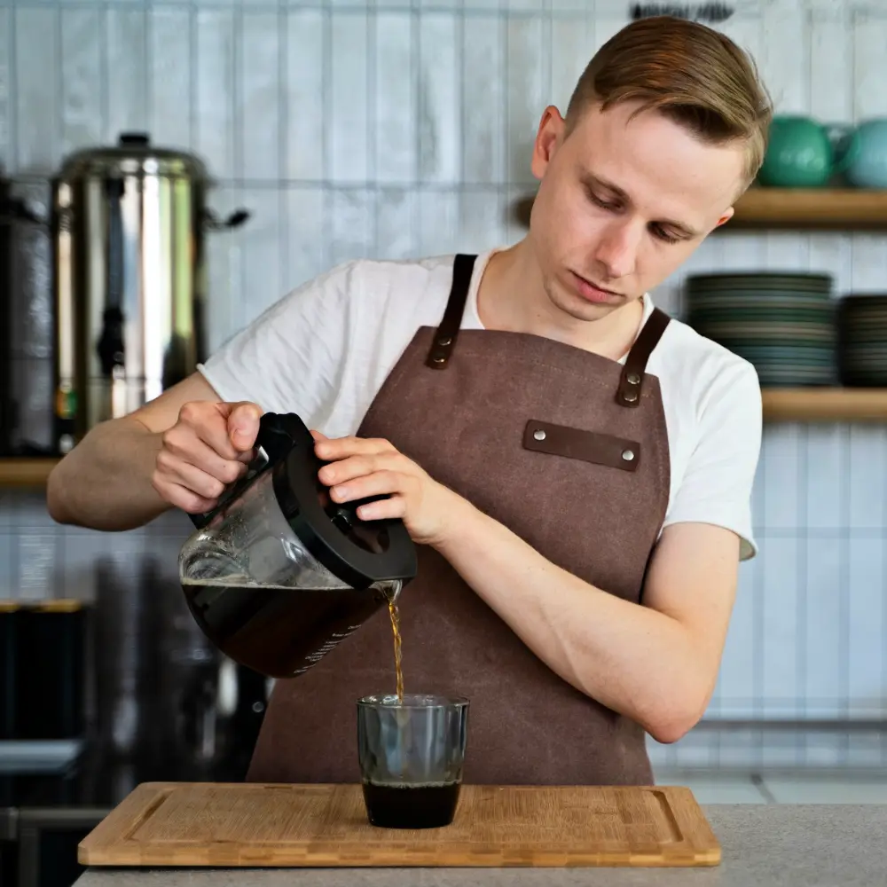 male barista making coffee looking sharp and well maintained