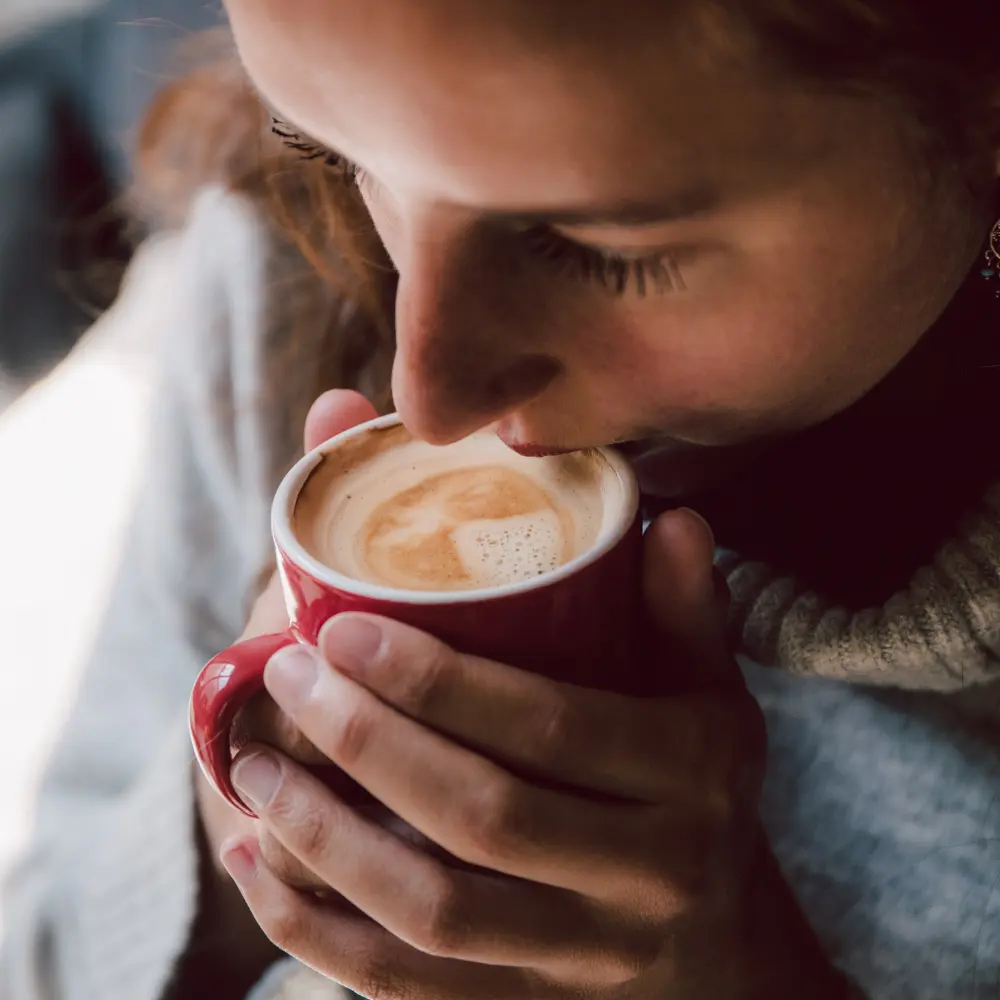 woman embracing her cup of coffee