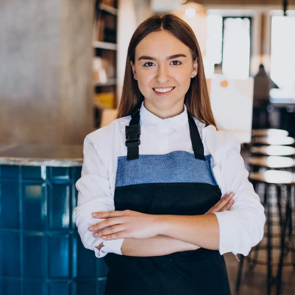 a young barista looking very professional in her café outfit
