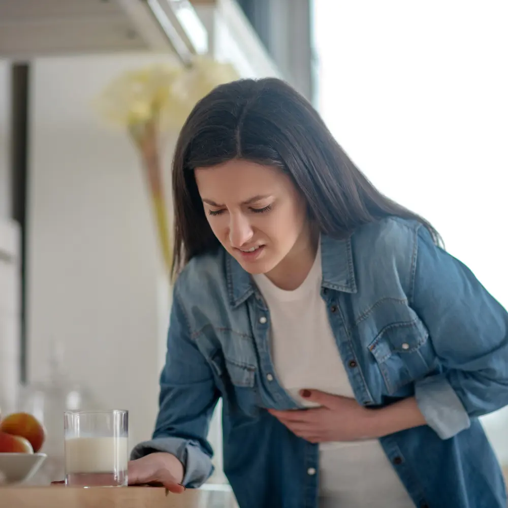woman holding her stomach in pain