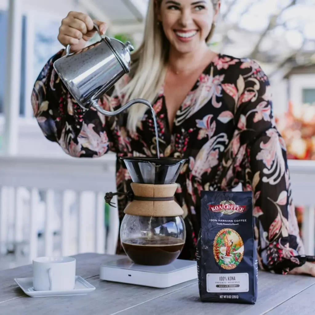 woman brewing koa coffee private reserve via pour over