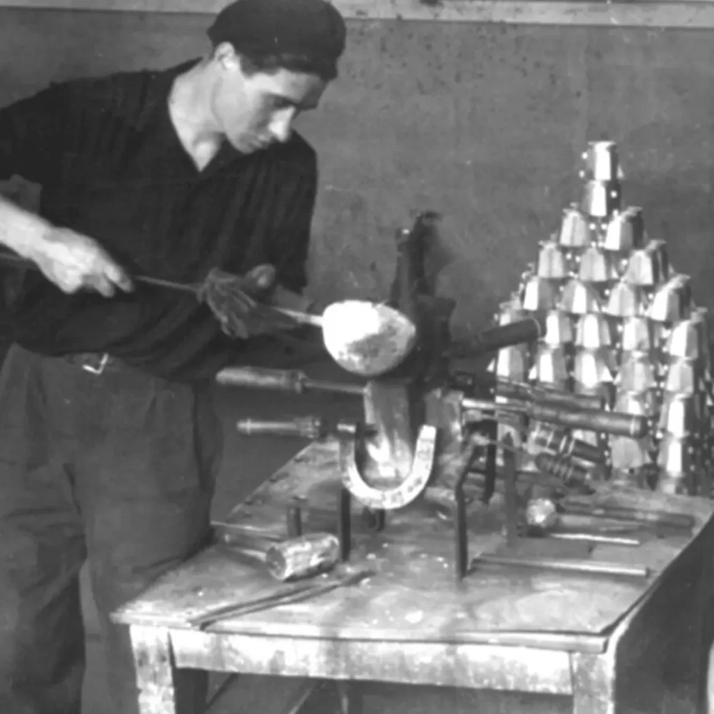historical photo of man working at the bialetti factory