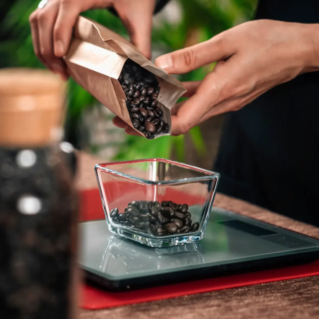 weighing coffee beans on a scale