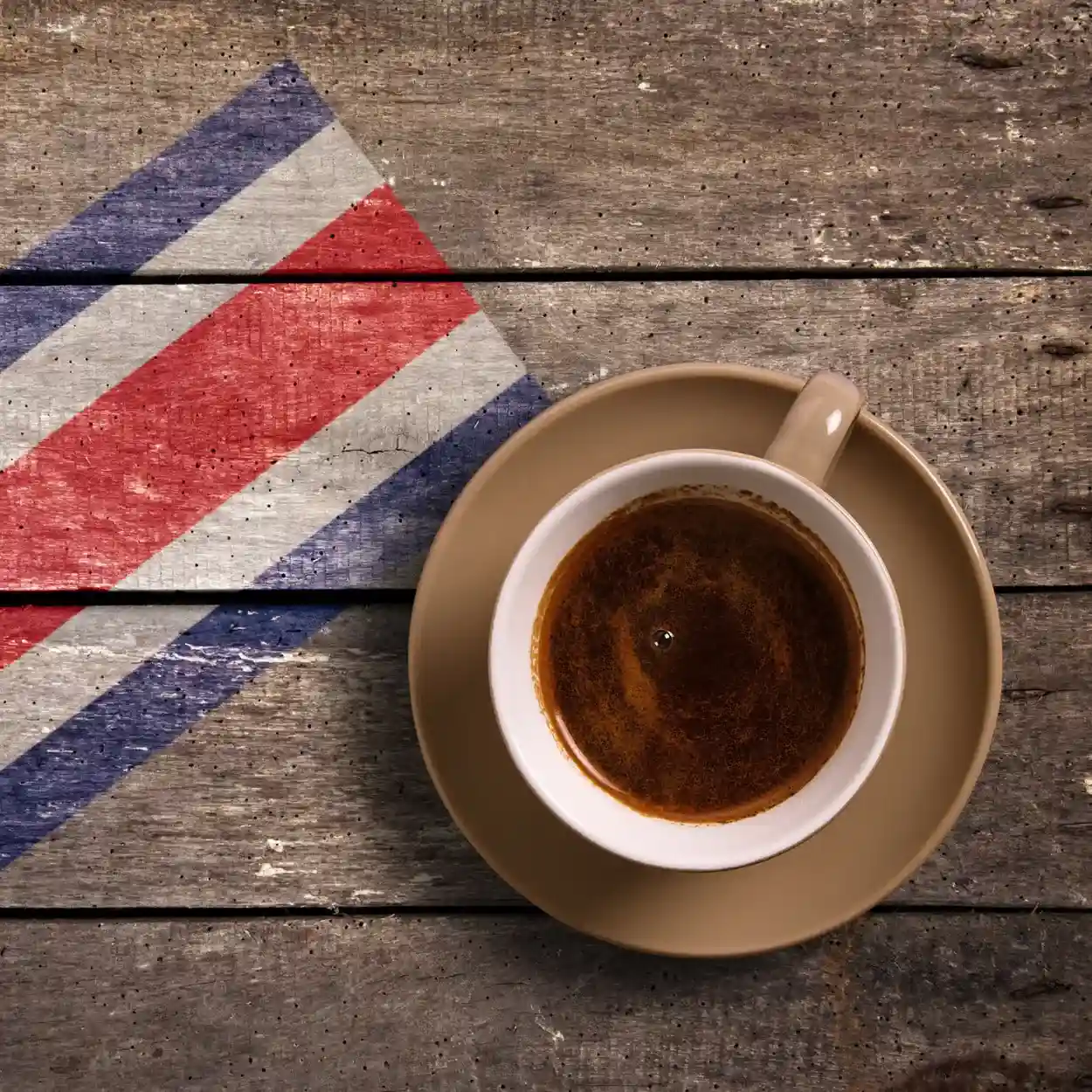 cup of coffee on saucer with costa rican flag on table