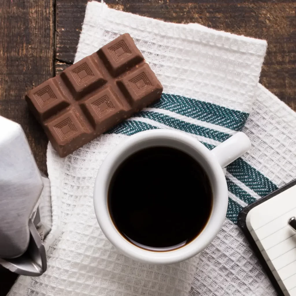 a black cup of coffee with chocolate
