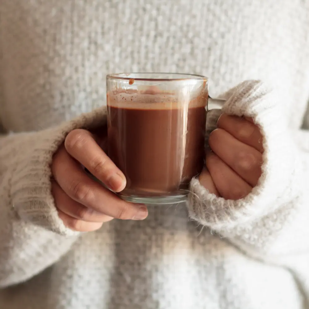 woman holding a delicious hot chocolate drink