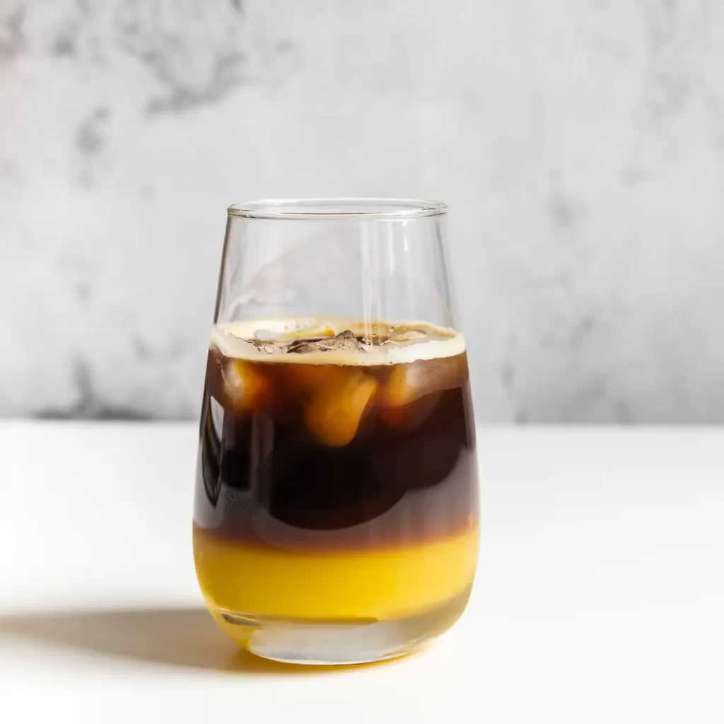 a glass of coffee with and ice