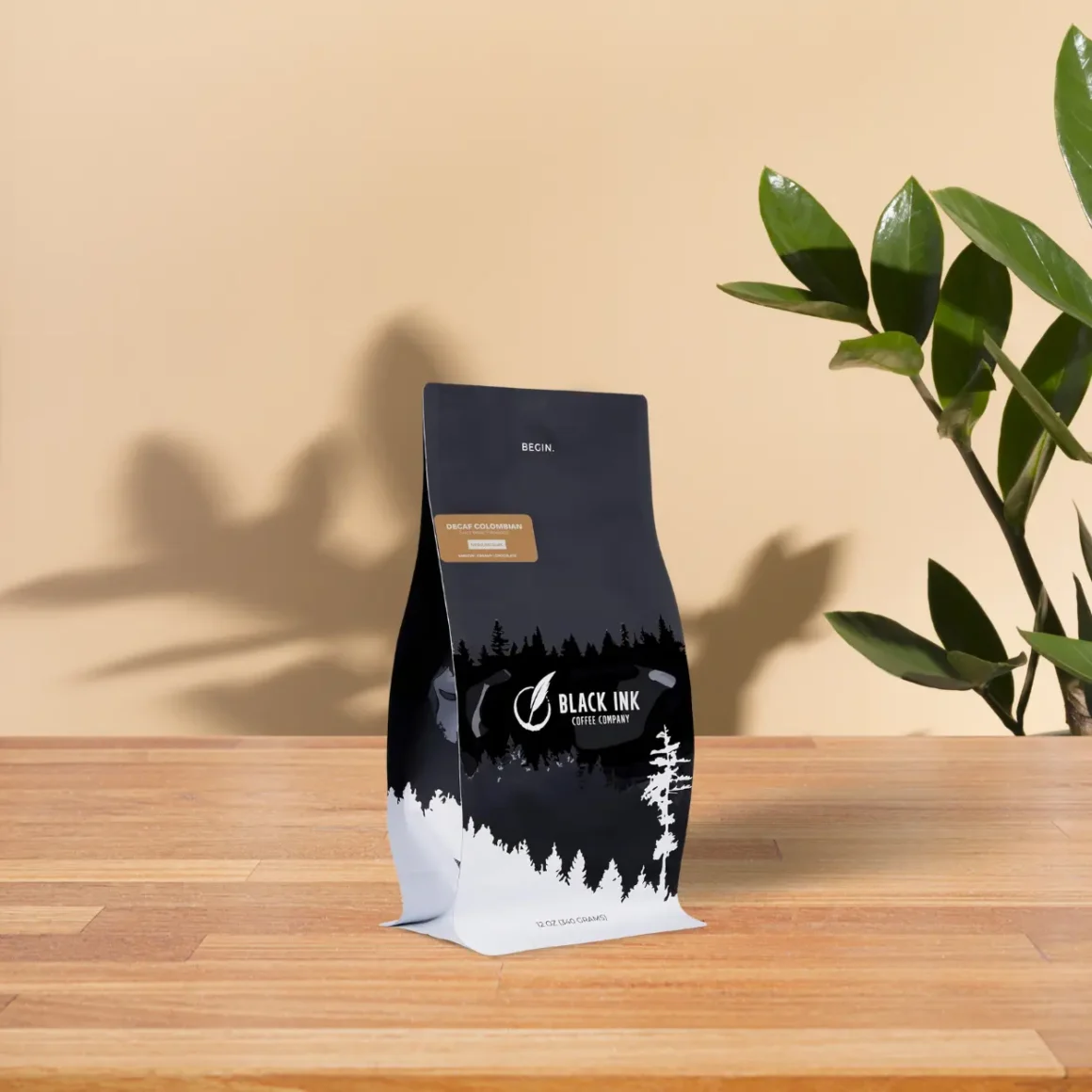 a bag of black ink swiss water decaf coffee on a table