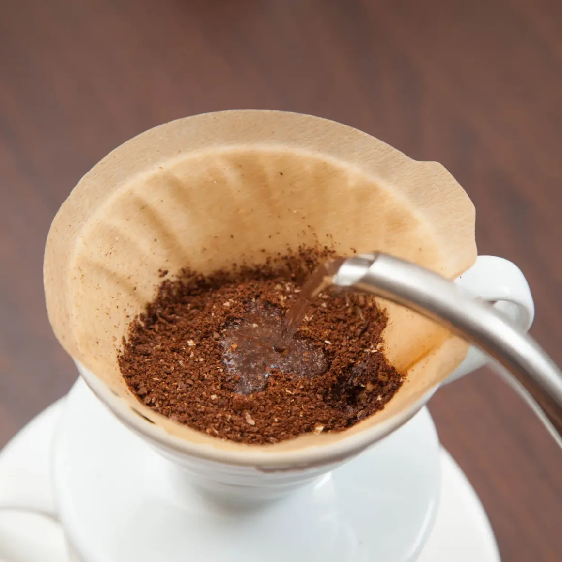 pouring water into a white cup