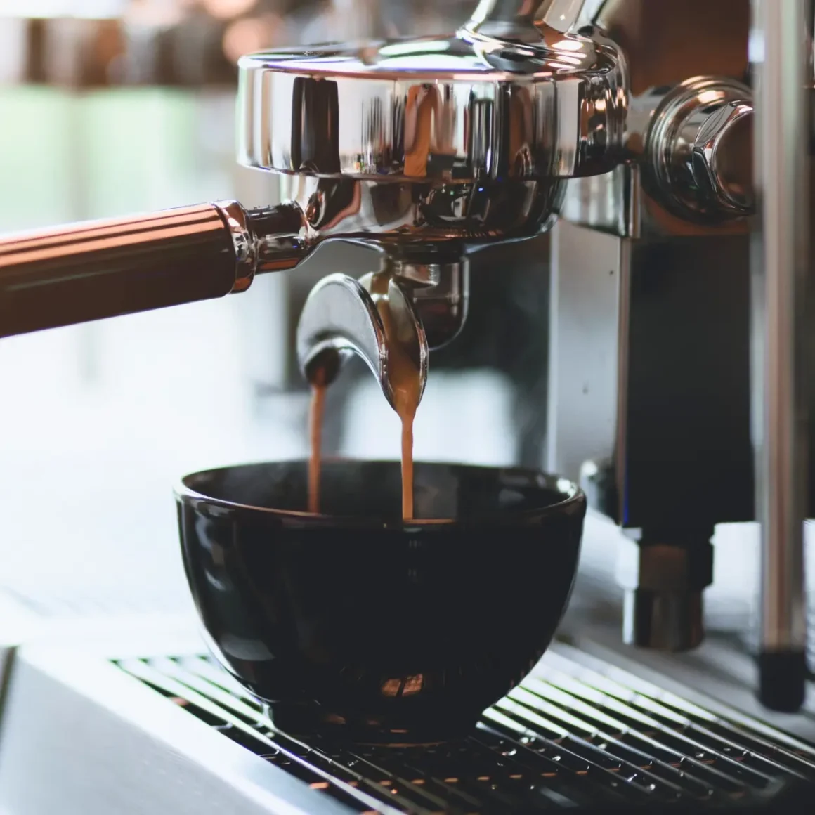 a coffee machine pouring coffee into a cup