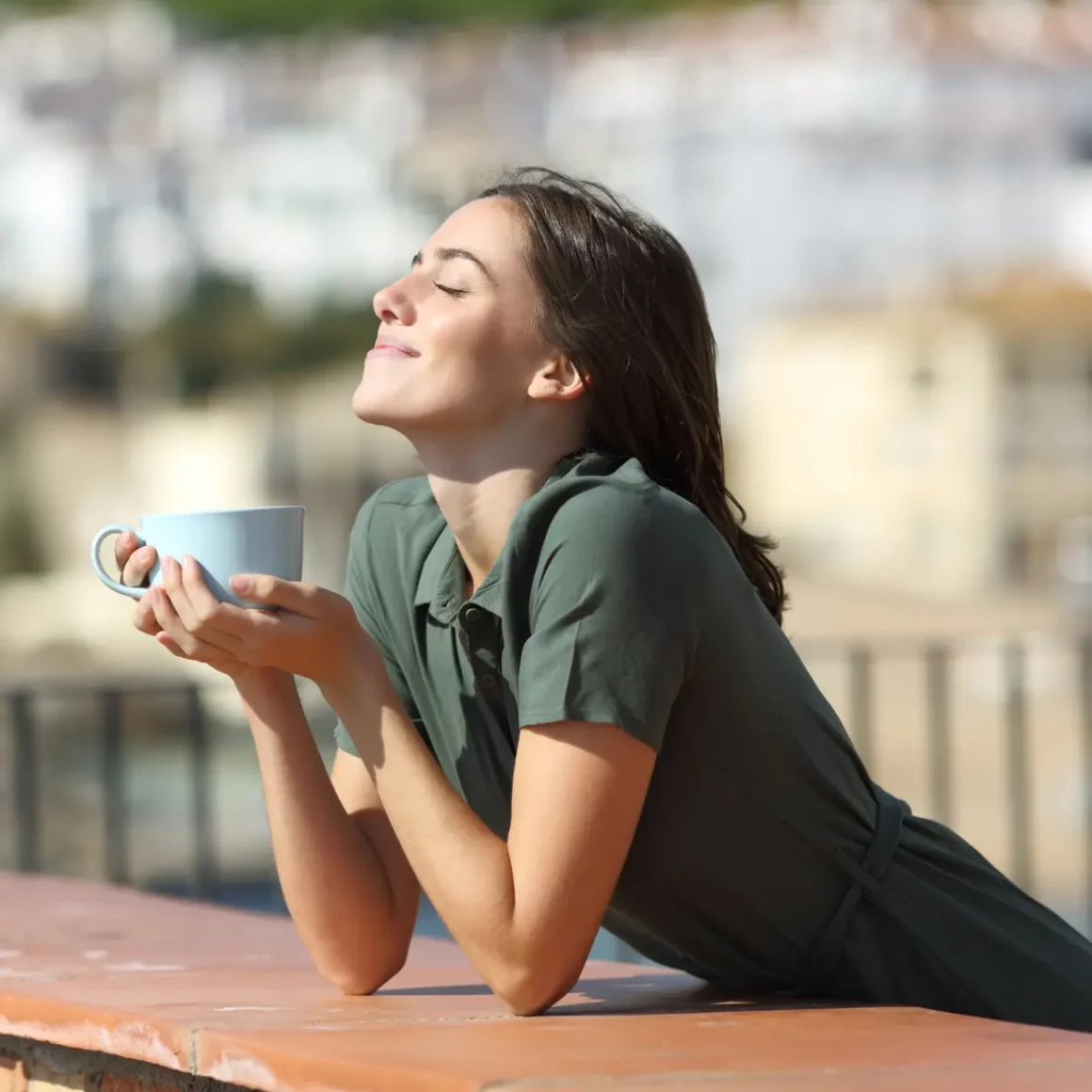 a woman holding a cup of coffee