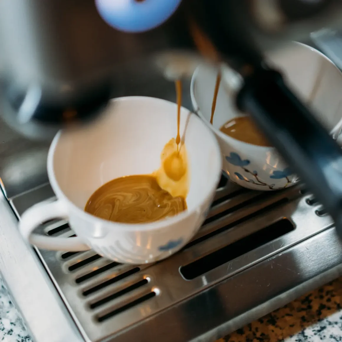 a coffee machine pouring coffee into a cup