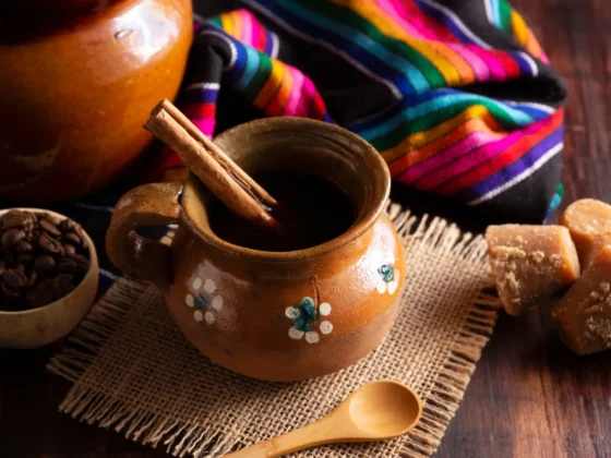 a clay pot with a wooden spoon