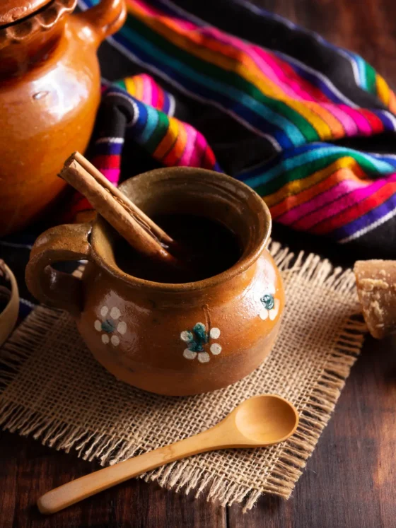 a clay pot with a wooden spoon