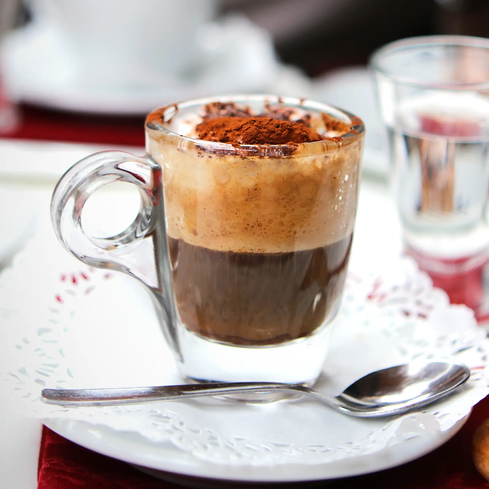a glass cup of coffee with a spoon
