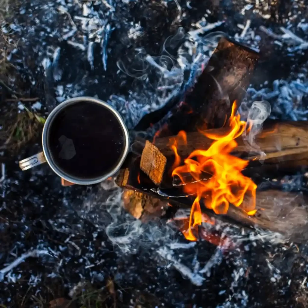 a cup of coffee over a fire