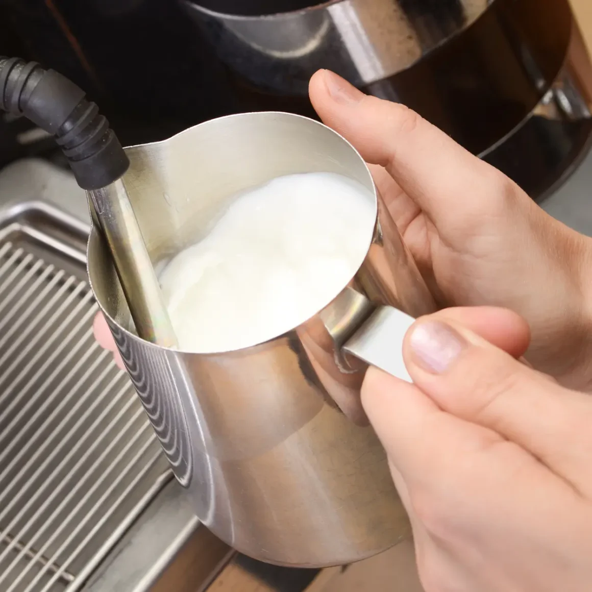 a person steaming milk