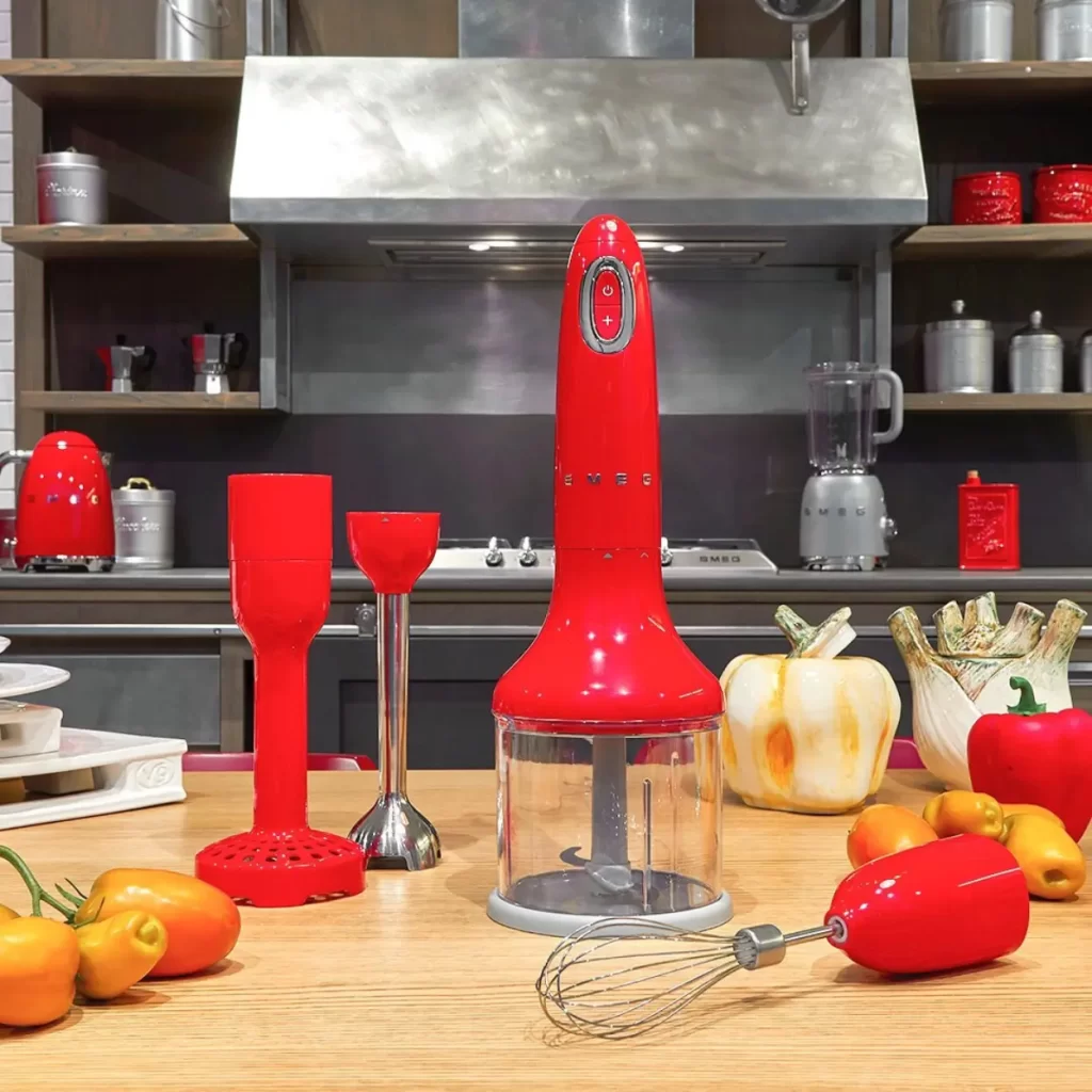 a kitchen counter with red blender and other kitchen appliances