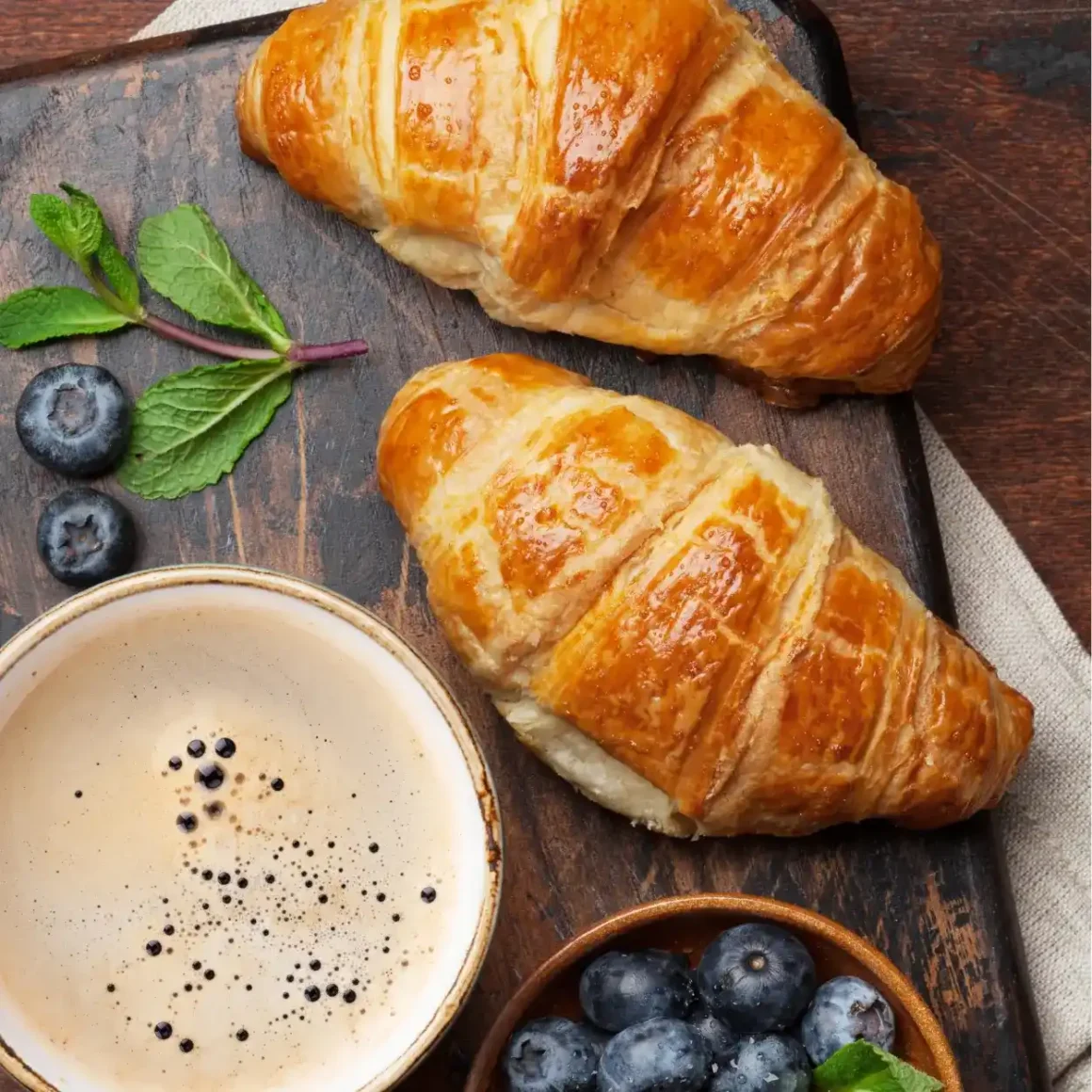 a croissants and a cup of coffee